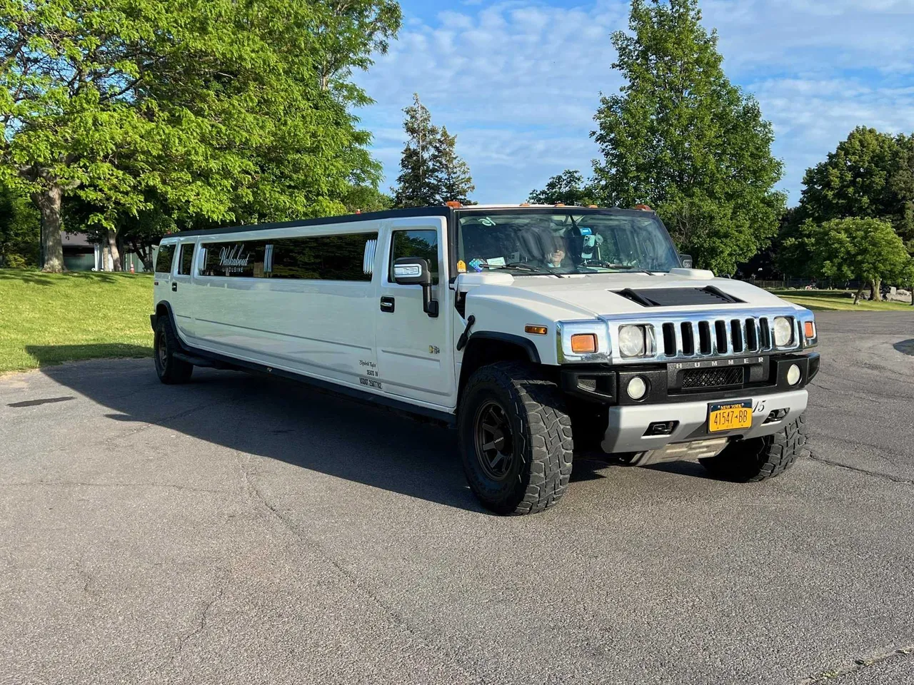 White Hummer H2 Limousine - Elizabeth Taylor with tinted windows for limo rental White Hummer H2 Limousine - Elizabeth Taylor with tinted windows for limo rental